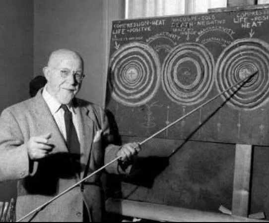 Source photograph of Walter Russell beside his wave diagrams
